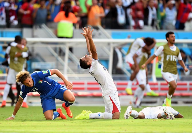 Michael Umana of Costa Rica (centre) celebrates after winning the match against Italy.