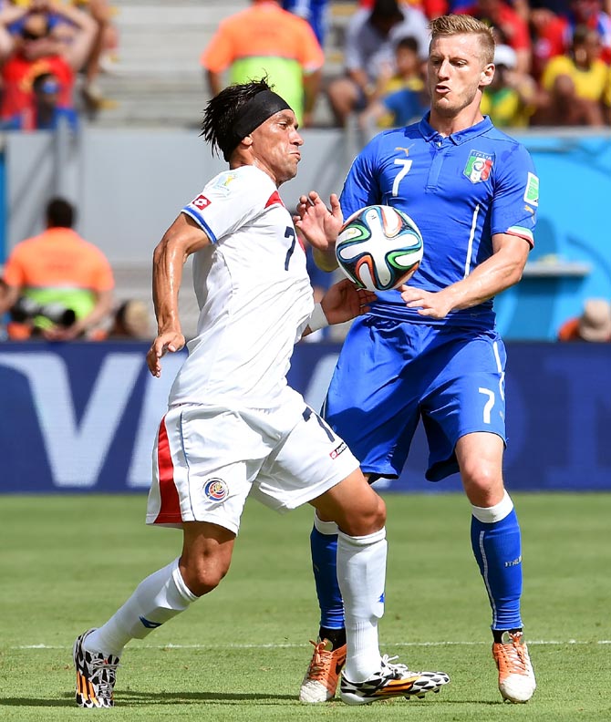 Costa Rica's Bolanos (left) and Ignazio Abate of Italy compete for the ball 