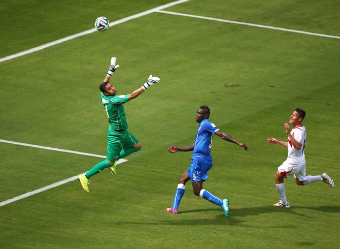 Italy striker Mario Balotelli (centre) shoots wide past goalkeeper Keylor Navas of Costa Rica