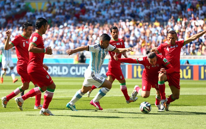 Sergio Aguero of Argentina tries to get the ball past Iran's defenders