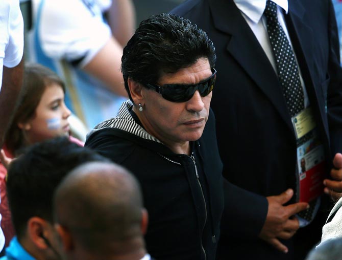 Diego Maradona watches the action from the stands