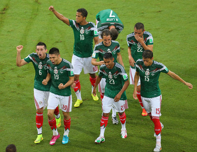 Oribe Peralta of Mexico (19) runs to the sidelines to celebrate his goal with teammates