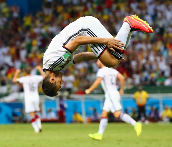 Miroslav Klose does a sommersault to celebrate scoring Germany's second goal