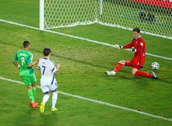 Peter Odemwingie of Nigeria scores past Asmir Begovic of Bosnia