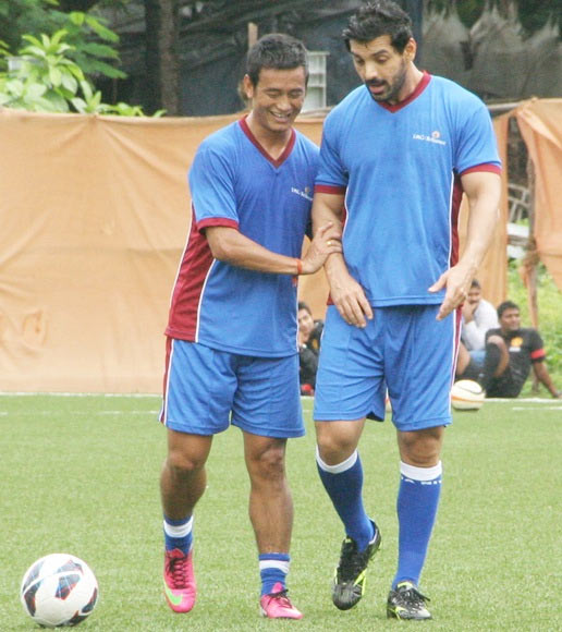 Baichung Bhutia with actor John Abraham during a training session