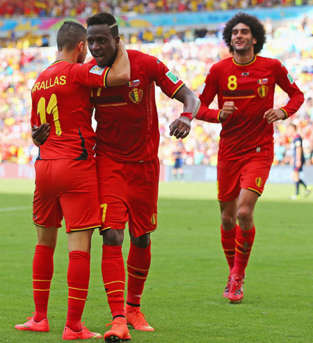 Divock Origi of Belgium (center) celebrates scoring his team's first goal with Kevin Mirallas