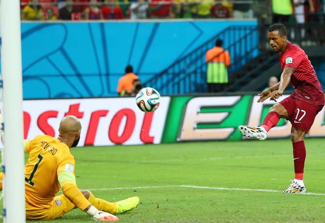 Nani of Portugal scores his team's first goal past goalkeeper Tim Howard of the United States