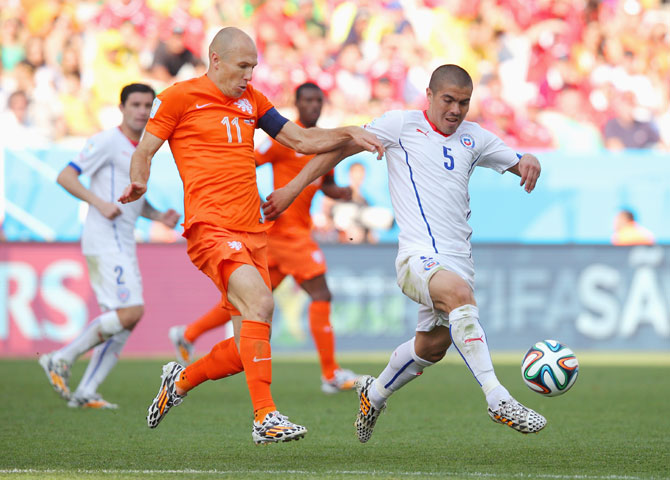 Francisco Silva of Chile controls the ball against Arjen Robben of the Netherlands
