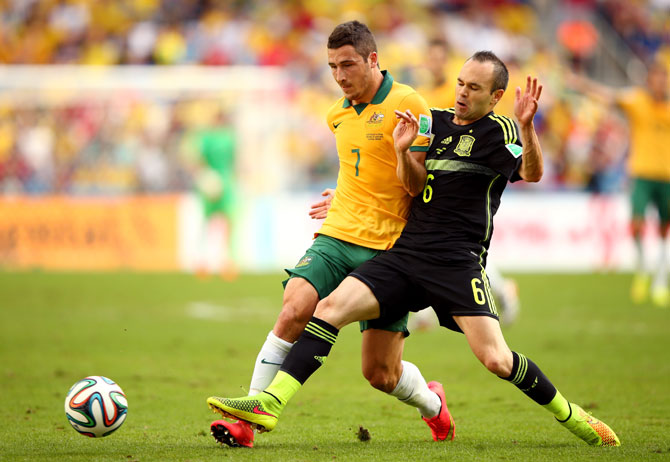 Mathew Leckie of Australia is challenged by Andres Iniesta of Spain