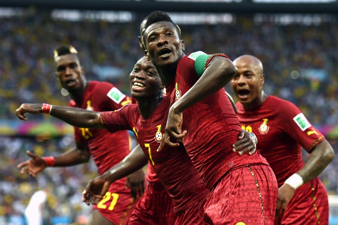 Asamoah Gyan (centre) of Ghana celebrates scoring his team's second goal against Germany.