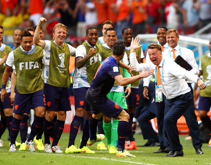 Robin van Persie of the Netherlands (centre) celebrates with head coach Louis van Gaal after scoring the first goal against Spain.
