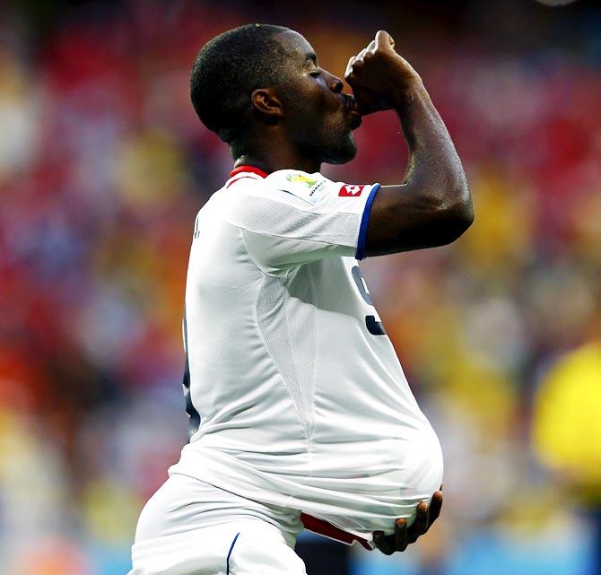 Costa Rica's Joel Campbell celebrates with the match ball after scoring against Uruguay