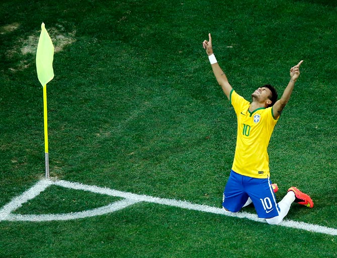 Brazil striker Neymar celebrates after scoring his second goal against Croatia.