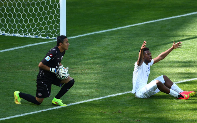 Daniel Sturridge of England reacts after a challenge as goalkeeper Keylor Navas of Costa Rica looks on