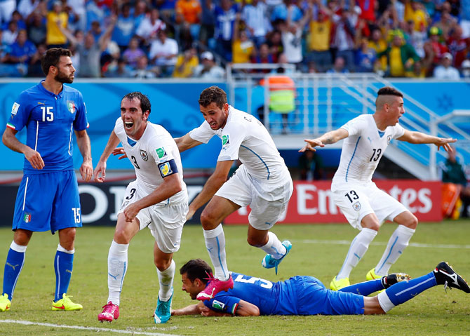 Diego Godin of Uruguay scores his team's first goal past goalkeeper Gianluigi Buffon of Italy