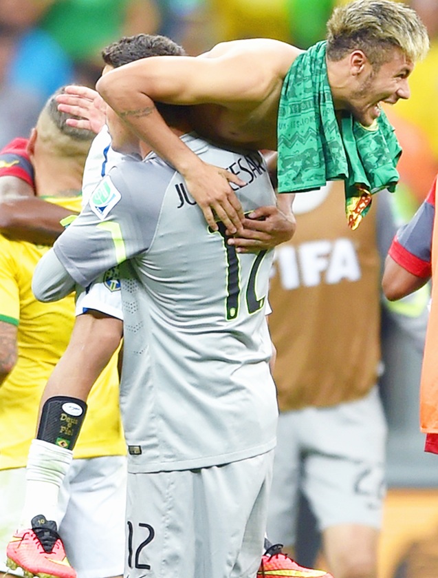 Goalkeeper Julio Cesar and Neymar of Brazil celebrate after defeating Cameroon