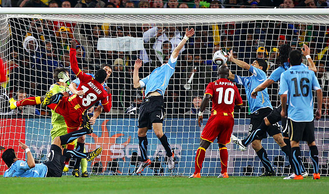 Luis Suarez of Uruguay handles the ball on the goal line, for which he was sent off, during the 2010 FIFA World Cup South Africa quarter-final against Ghana at the Soccer City stadium Johannesburg