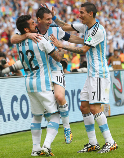 Lionel Messi of Argentina celebrates scoring his team's second goal and his second of the game with Ezequiel Lavezzi (left) and Angel di Maria (right)