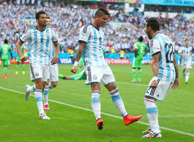 Marcos Rojo of Argentina (center) celebrates scoring his team's third goal with Ezequiel Garay (left) and Ezequiel Lavezzi