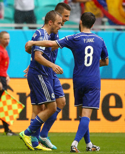 Avdija Vrsajevic of Bosnia and Herzegovina (center) celebrates with his teammates scoring his team's third goal