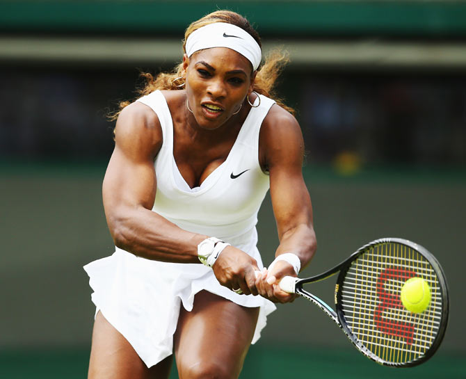 Serena Williams plays a return against Chanelle Scheepers of South Africa