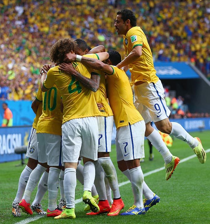 Brazil's players celebrate after Neymar scored the first goal against Cameroon