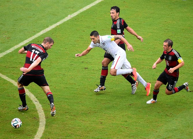 Clint Dempsey (centre) of the US competes tries to get the ball past the German defenders