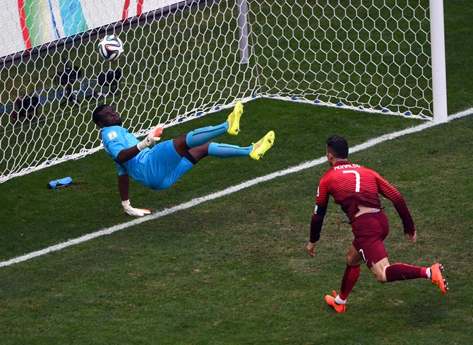 Ghana goalkeeper Fatawu Dauda (left) saves the header from Cristiano Ronaldo 