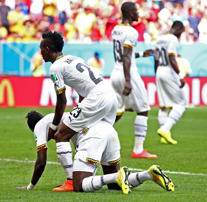 Harrison Afful consoles John Boye of Ghana after he scored an own goal