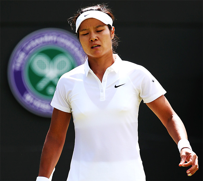 Li Na of China stands dejected after losing her third round match to Barbora Zahlavova Strycova of Czech Republic