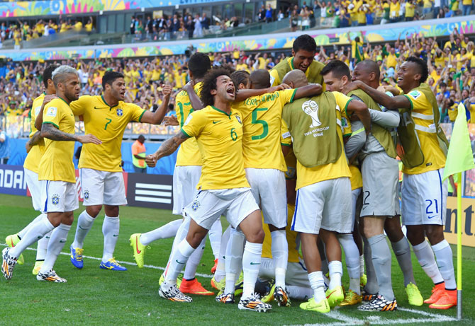 David Luiz of Brazil celebrates scoring his team's first goal with teammates