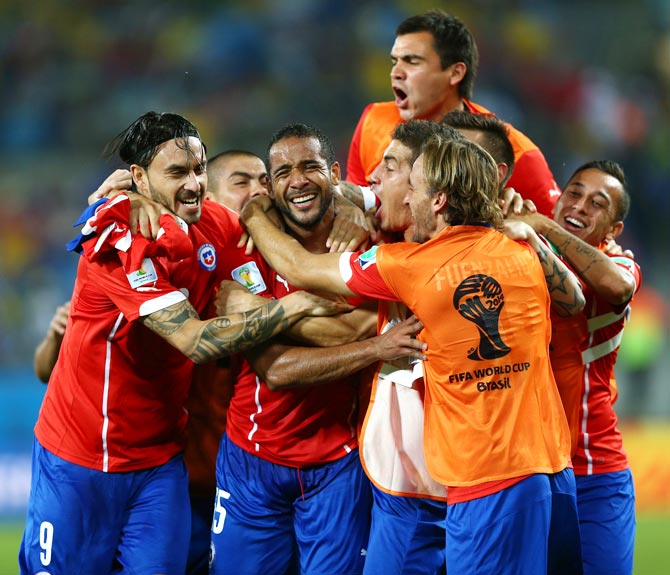 Chile's players celebrate after winning their match against Australia.