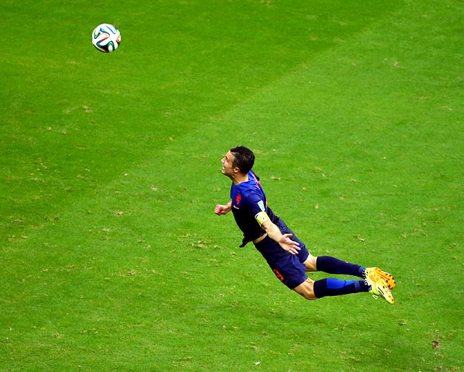 Robin van Persie of the Netherlands scores the first goal with a diving header against Spain