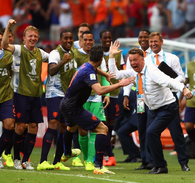 Robin van Persie of the Netherlands (centre) celebrates with head coach Louis van Gaal