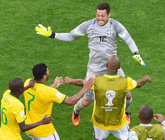 Julio Cesar of Brazil celebrates with teammates after defeating Chile in a penalty shootout