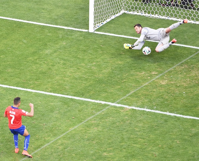 Alexis Sanchez of Chile takes a penalty and has it saved by Julio Cesar of Brazil in a shootout