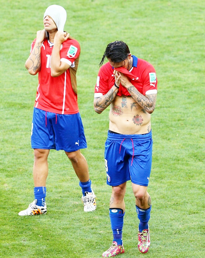 Jorge Valdivia and Mauricio Pinilla of Chile look dejected after being defeated by Brazil in the penatly shootout