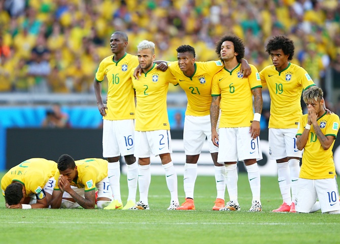 Thiago Silva, Luiz Gustavo, Ramires, Dani Alves, Jo, Marcelo, Hulk, Willian and Neymar of Brazil look on during a penalty shootout