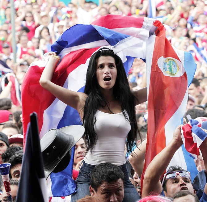 Costa Rica's fans celebrate after their team scored a goal against Greece