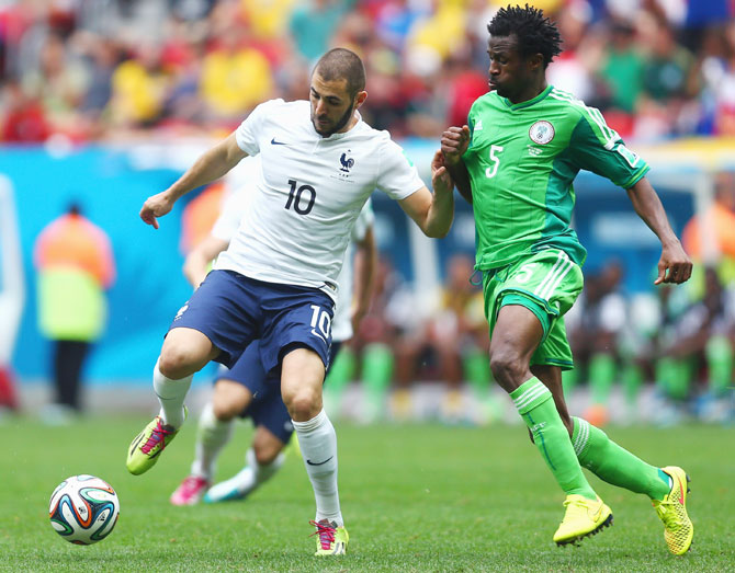 Karim Benzema of France controls the ball against Efe Ambrose of Nigeria