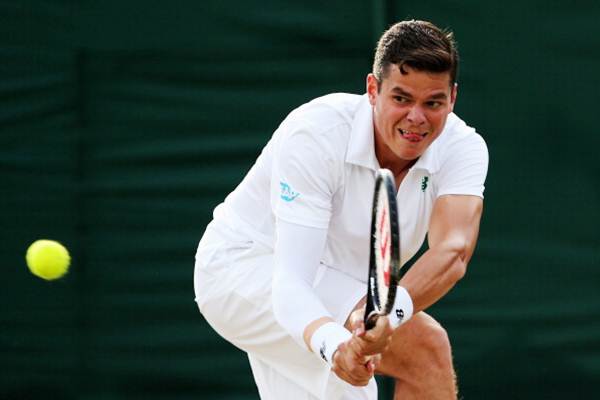 Milos Raonic of Canada plays a backhand return during his third round match against Lukasz Kubot of Poland