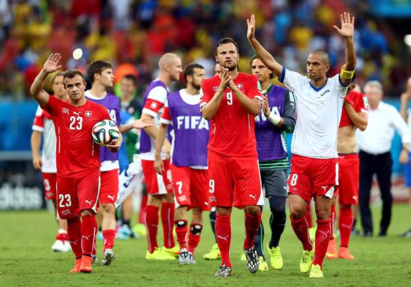 Xherdan Shaqiri, Haris Seferovic and Gokhan Inler of Switzerland acknowledge the fans after a 3-0 victory over Honduras 