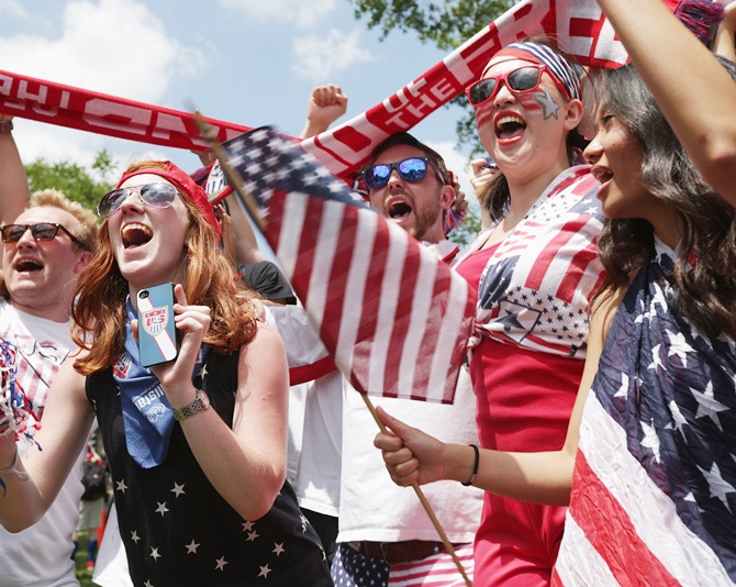Fans cheer after hearing the news that Team USA will advance to the next round of the World Cup