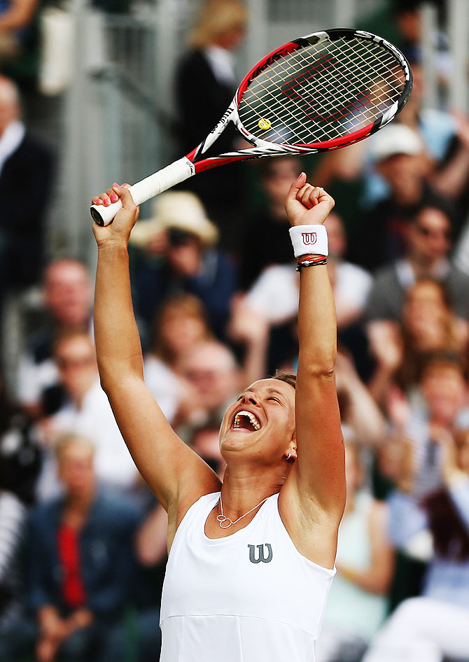 Barbora Zahlavova Strycova of Czech Republic celebrates after winning her fourth round match against Caroline Wozniacki of Denmark at the All England Lawn Tennis and Croquet Club on Monday