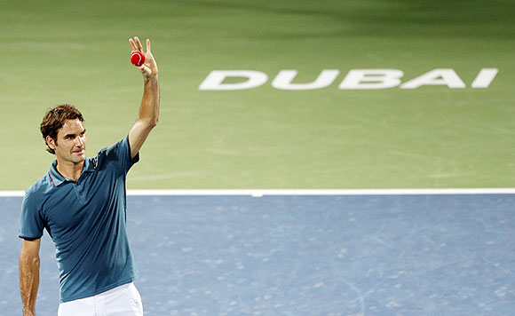 Roger Federer of Switzerland celebrates after defeating Novak Djokovic of Serbia in their men's singles semi-final match at the ATP Dubai Tennis Championships on Friday