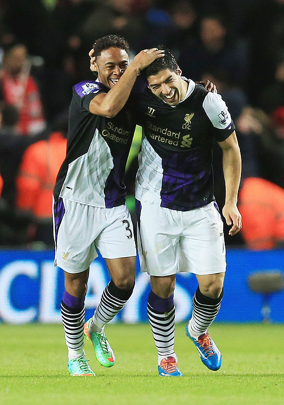 Liverpool's Raheem Sterling (left) celebrates his goal with Luis Suarez on Saturday