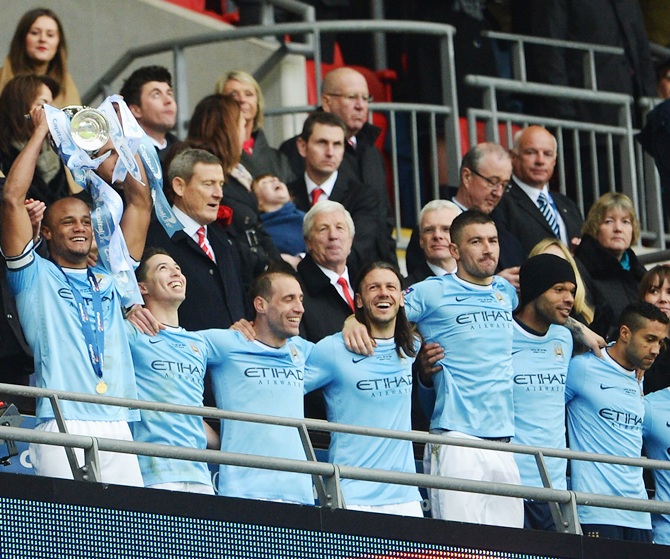 Vincent Kompany of Manchester City lifts the trophy with team mates after the League Cup final against Sunderland at Wembley Stadium.