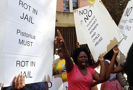 Women protest outside the Pretoria Magistrates court, during the bail application hearing of South African athlete Oscar Pistorius.