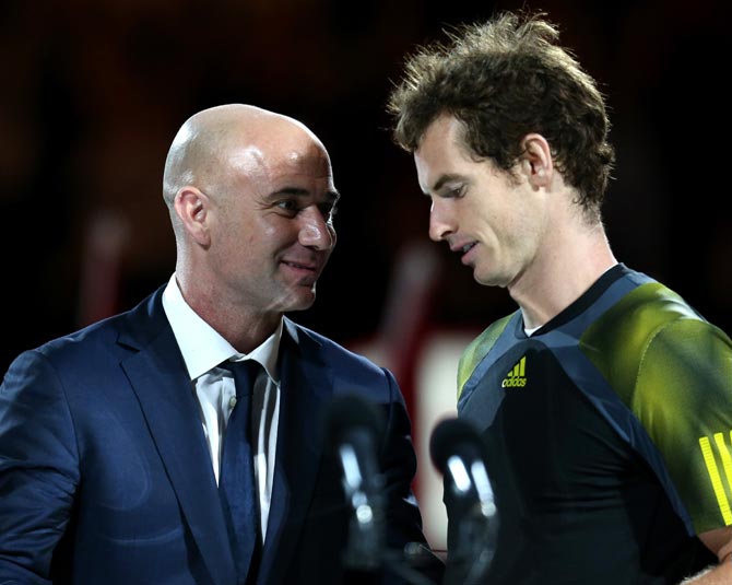 Andre Agassi (left) speaks to Andy Murray