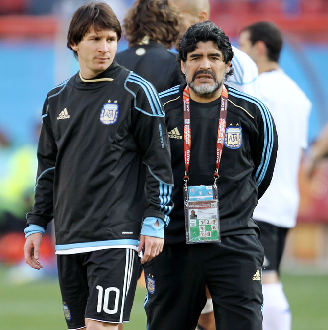 Diego Maradona head coach of Argentina conducts warm up exercises with striker Lionel Messi